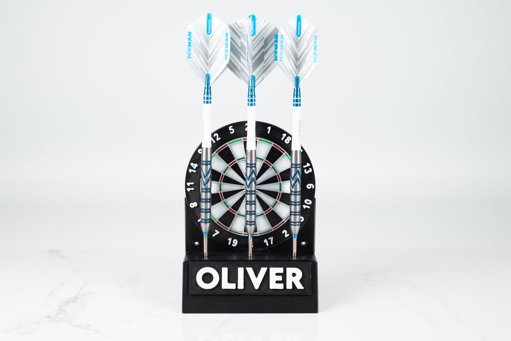 Dartboard-themed display stand holding three darts with an Oliver name plate